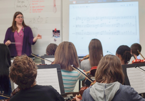 Educator in front of music class